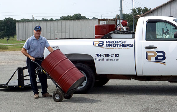 man delivering packaged lubricant oil drum