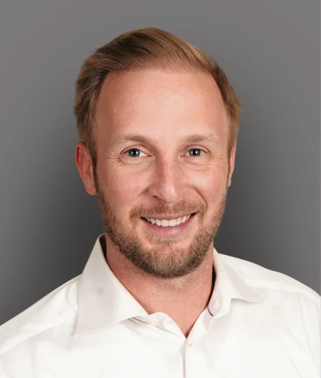Professional headshot of Will Propst on gray background